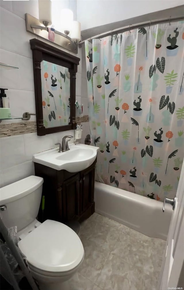 full bathroom with shower / tub combo, vanity, toilet, and tile walls