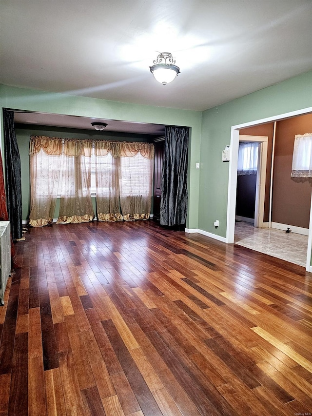 unfurnished room with wood-type flooring