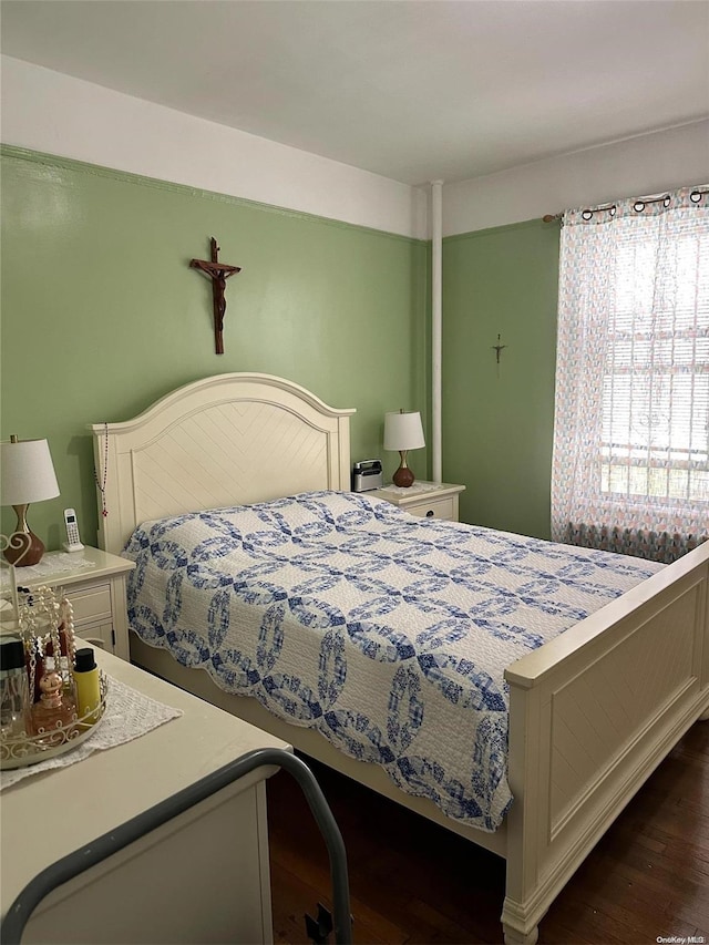 bedroom with dark wood-type flooring