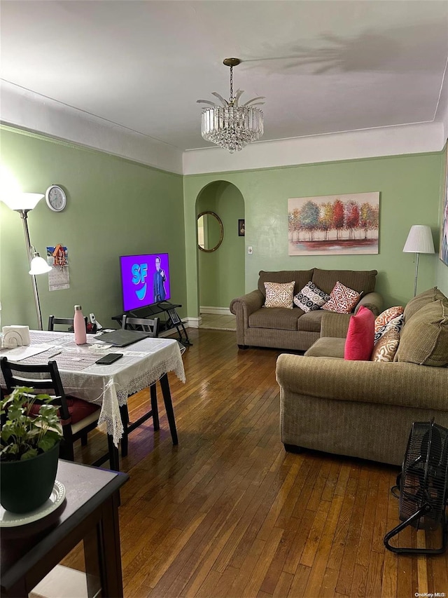 living room with dark wood-type flooring and a chandelier