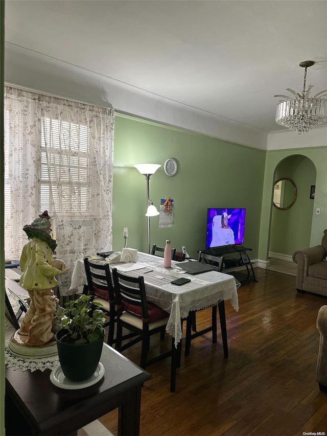 dining room with a notable chandelier and dark hardwood / wood-style floors