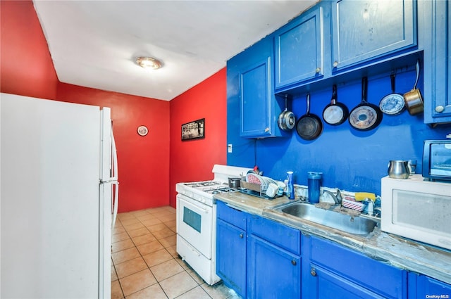 kitchen featuring light tile patterned floors, white appliances, blue cabinets, and sink