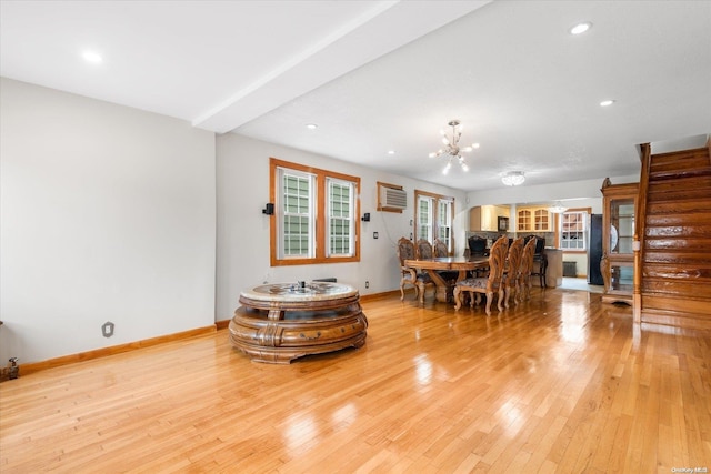 dining room featuring light hardwood / wood-style floors and a notable chandelier