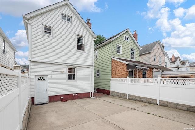 rear view of property featuring a patio area