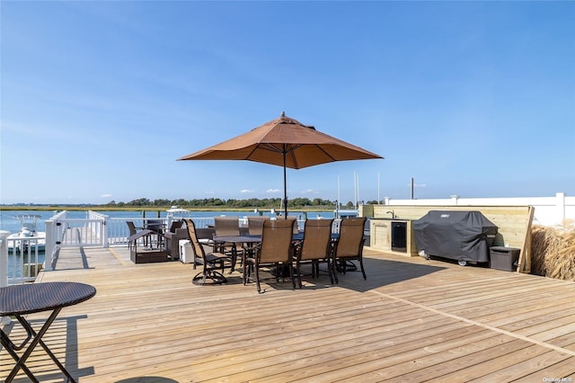 wooden terrace featuring a water view and area for grilling