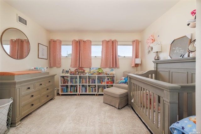 carpeted bedroom with a nursery area