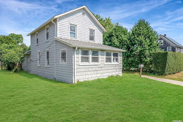 view of side of property with a yard