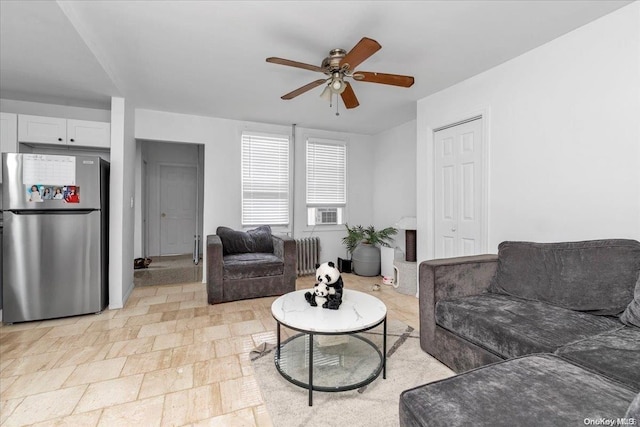 living room with ceiling fan, radiator heating unit, and cooling unit