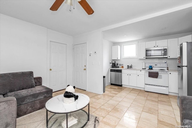 tiled living room with ceiling fan