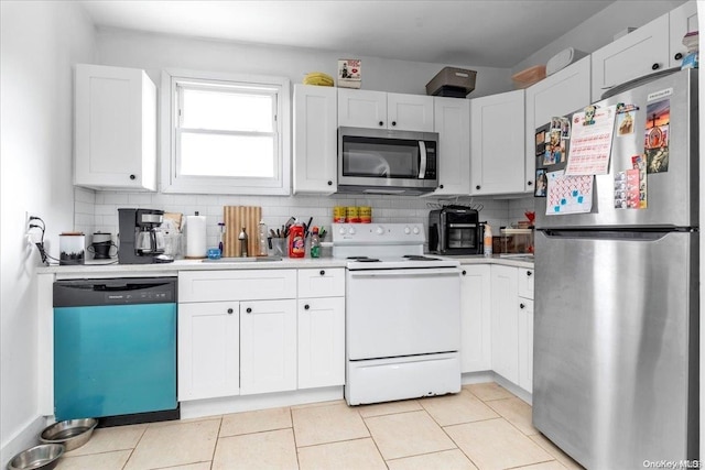 kitchen featuring backsplash, sink, white cabinetry, and stainless steel appliances