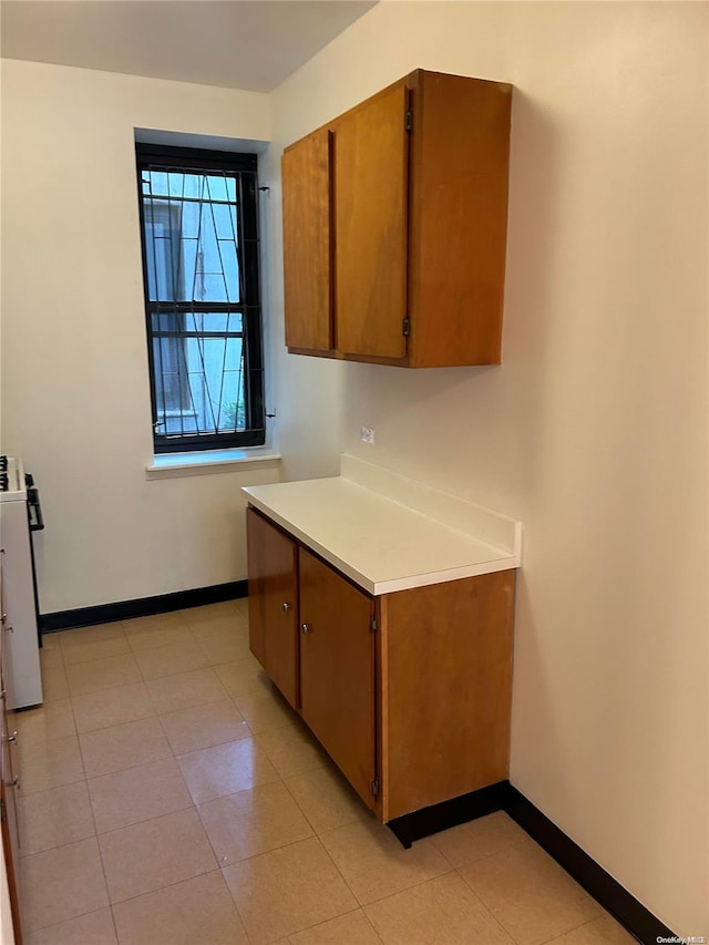 kitchen featuring light tile patterned floors and white range