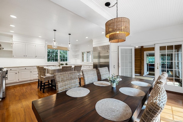 dining space with dark hardwood / wood-style floors, sink, and french doors