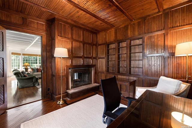 office space with beamed ceiling, hardwood / wood-style floors, wooden walls, and wood ceiling