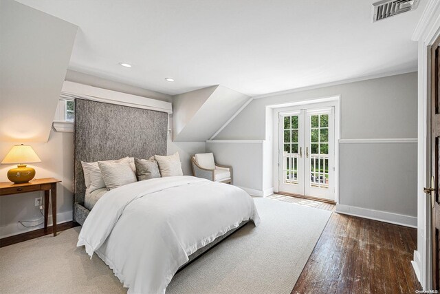 bedroom with access to exterior, french doors, dark hardwood / wood-style floors, and lofted ceiling