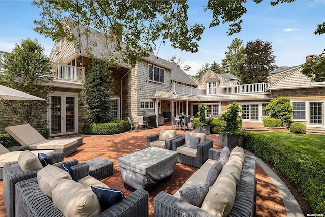 view of patio / terrace featuring outdoor lounge area, french doors, and a balcony