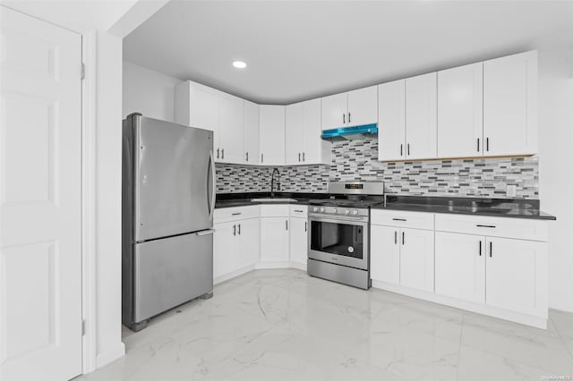 kitchen with white cabinets, backsplash, stainless steel appliances, and sink