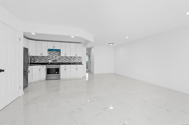 kitchen featuring white cabinetry, stainless steel appliances, and tasteful backsplash