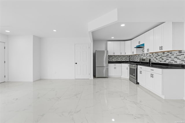 kitchen with decorative backsplash, white cabinets, and stainless steel appliances