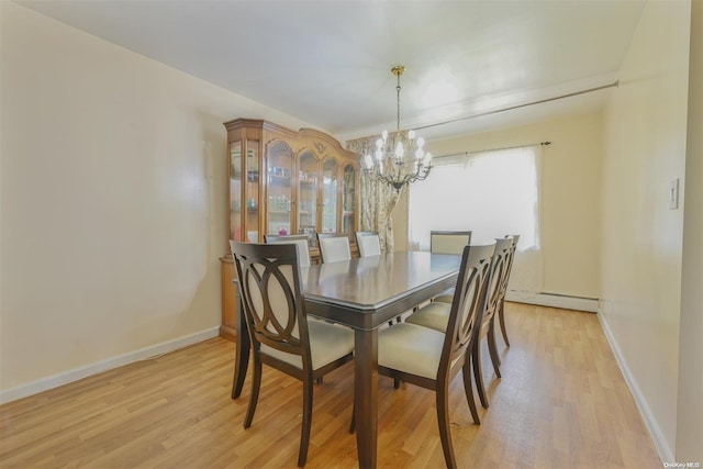 dining area featuring baseboard heating, light hardwood / wood-style flooring, and a notable chandelier