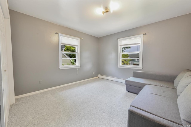 carpeted living room featuring baseboard heating