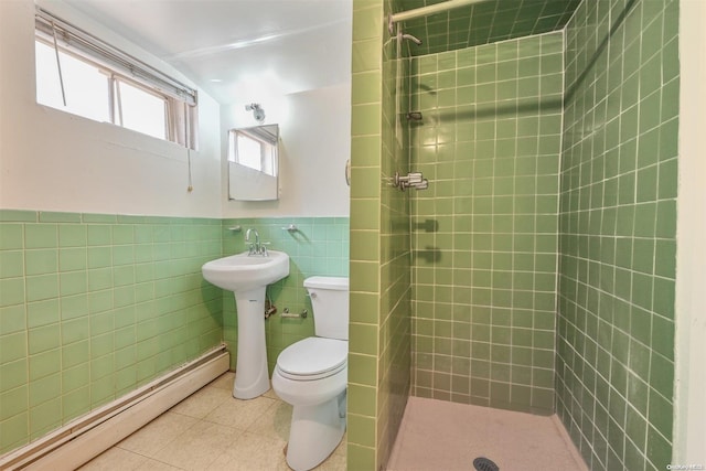 bathroom featuring a baseboard radiator, tile patterned floors, toilet, tiled shower, and tile walls