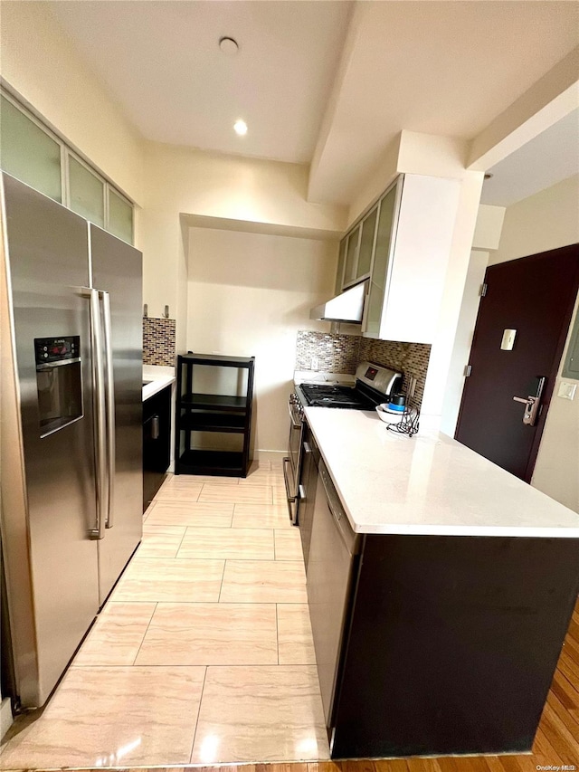 kitchen featuring decorative backsplash, stainless steel appliances, and light hardwood / wood-style floors