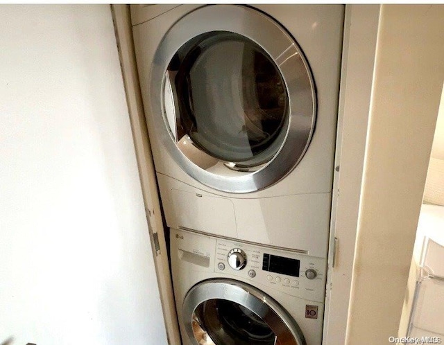 laundry room with stacked washing maching and dryer