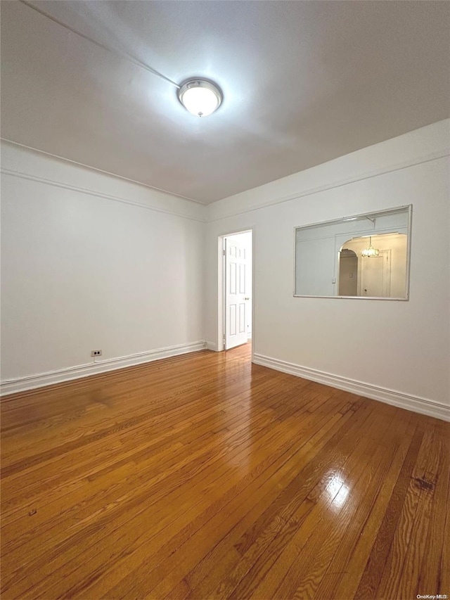 spare room featuring wood-type flooring