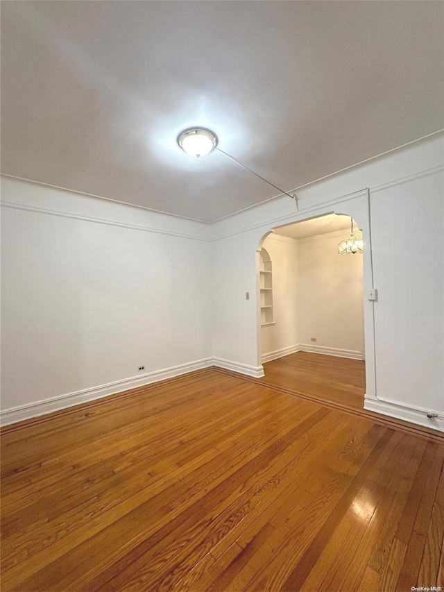 interior space featuring wood-type flooring and a notable chandelier