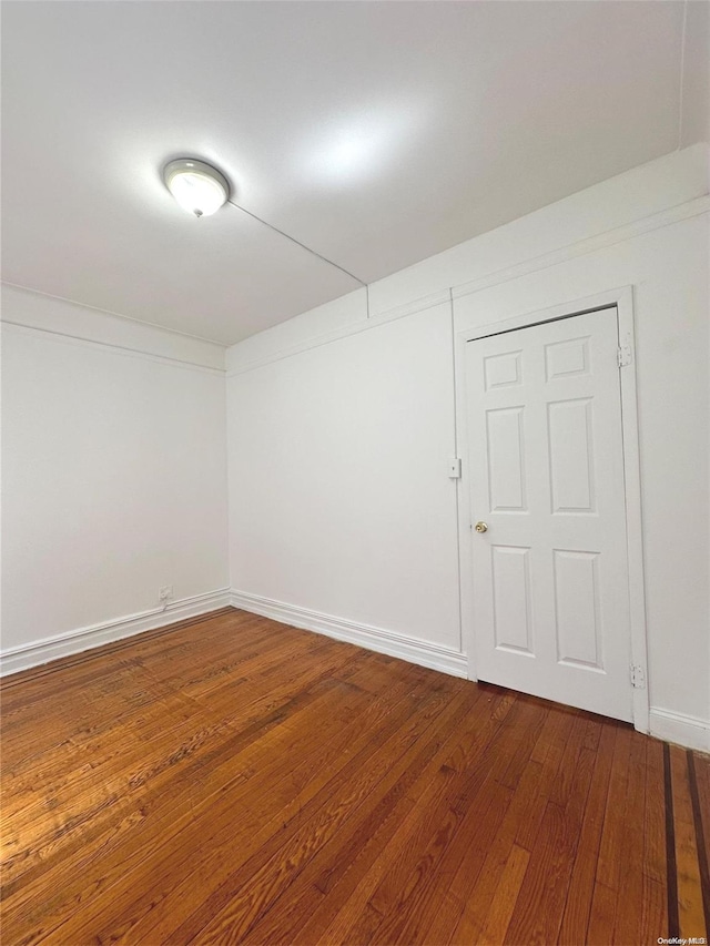 empty room with wood-type flooring