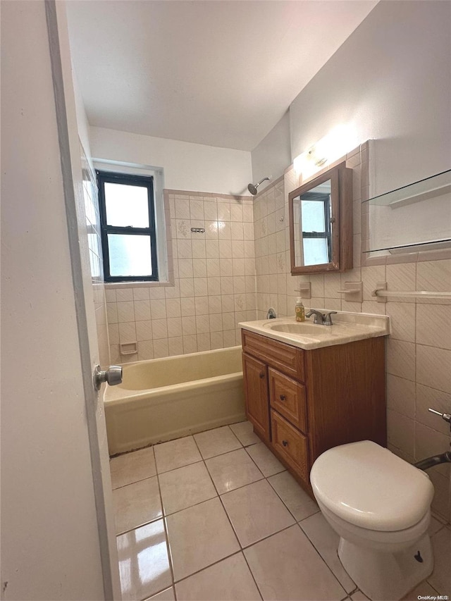 full bathroom with toilet, vanity, tile patterned floors, and tile walls