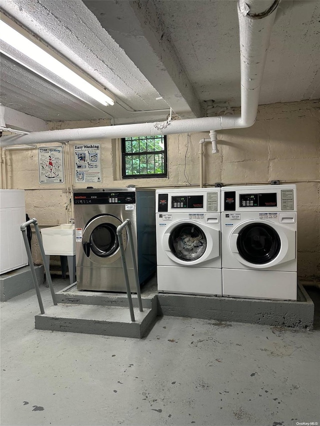 washroom with washing machine and dryer and sink