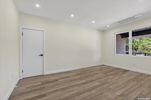 spare room featuring light hardwood / wood-style floors