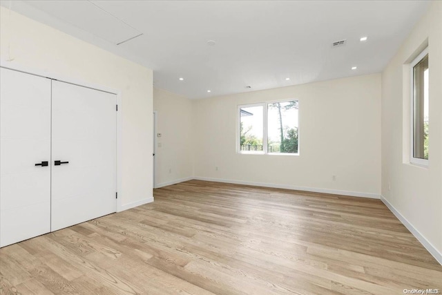 unfurnished bedroom with light hardwood / wood-style floors and a closet