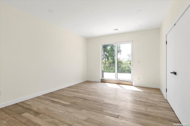 spare room featuring light hardwood / wood-style flooring