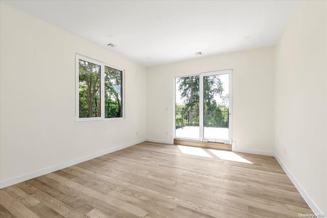 spare room featuring light hardwood / wood-style flooring