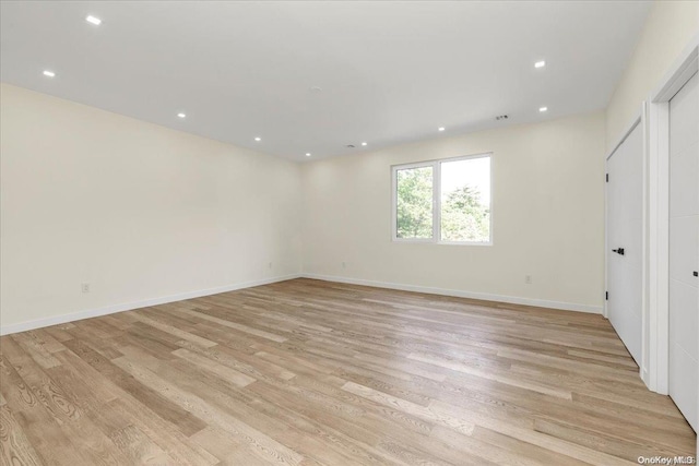 spare room featuring light hardwood / wood-style flooring