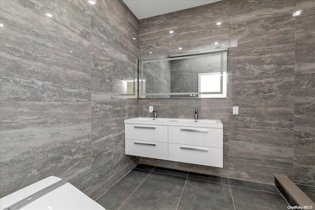 bathroom featuring vanity, tile patterned floors, and tile walls