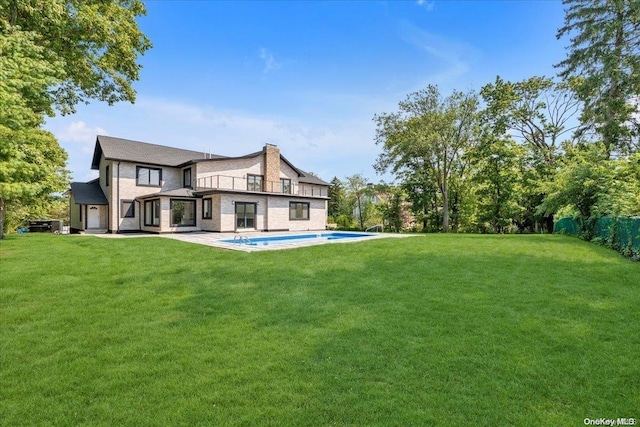 rear view of house with a lawn