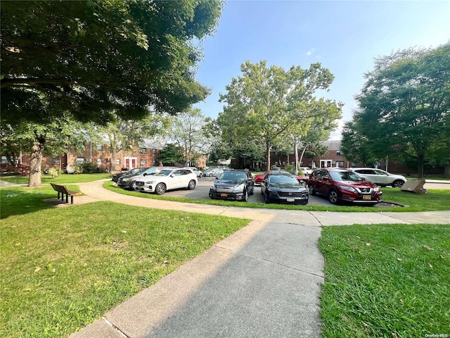 view of parking / parking lot with a yard