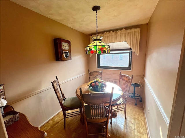 dining area with parquet floors