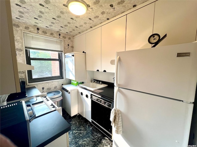 kitchen featuring white cabinetry, sink, white fridge, and black dishwasher