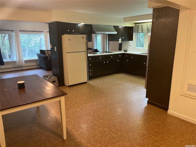 kitchen featuring stainless steel gas cooktop, ventilation hood, a baseboard heating unit, and white refrigerator