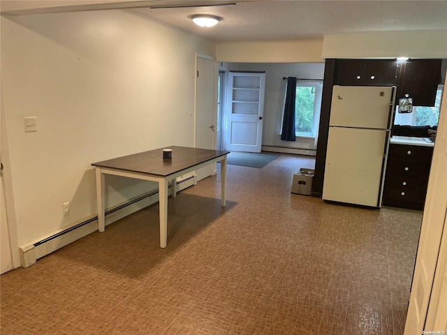 kitchen with carpet flooring, white fridge, and baseboard heating