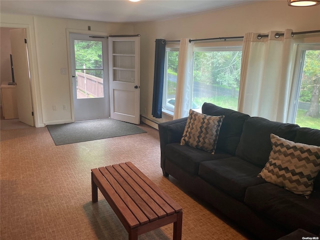 carpeted living room featuring baseboard heating and a healthy amount of sunlight