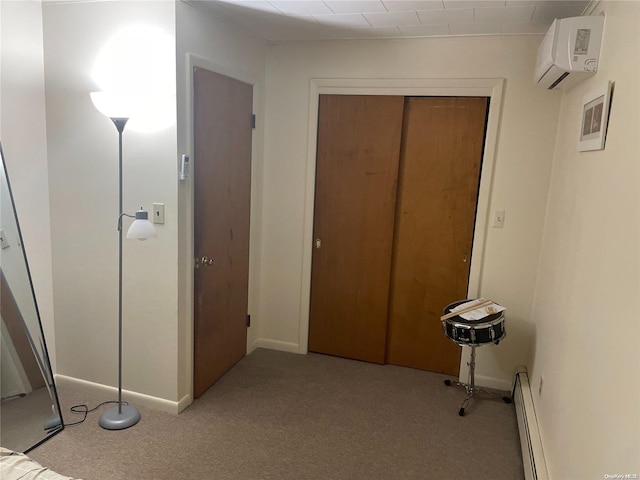 hall with light colored carpet, baseboard heating, and a wall mounted AC