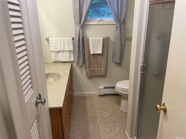 bathroom featuring tile patterned flooring, vanity, a baseboard radiator, and an enclosed shower