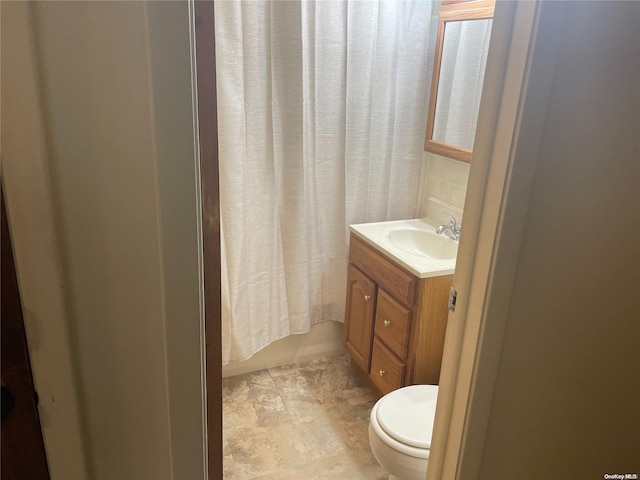 full bathroom with vanity, shower / bath combination with curtain, and toilet