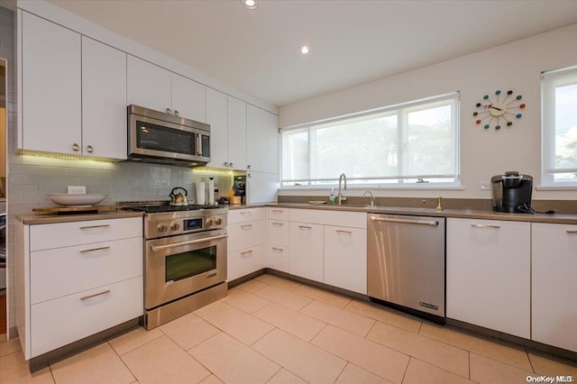 kitchen with white cabinets, plenty of natural light, sink, and appliances with stainless steel finishes