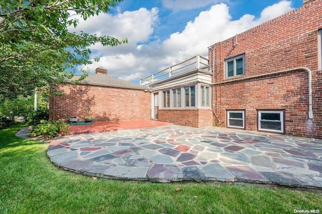 back of property featuring a patio area